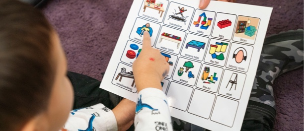 Child pointing to a figure on a chart