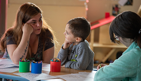 Teacher working one-on-one with a child at a table Teacher working one-on-one with a child at a table